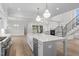 Spacious open concept kitchen and living area with a large center island and stainless appliances at 2642 Marchmont St, Raleigh, NC 27608