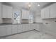 Laundry Room with bright white cabinets, gray countertops, and bright light at 2642 Marchmont St, Raleigh, NC 27608