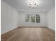 Bright living room featuring hardwood floors, bright light, and three windows at 2642 Marchmont St, Raleigh, NC 27608