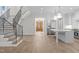 Open-concept living space with staircase, kitchen island, and stainless steel appliances at 2642 Marchmont St, Raleigh, NC 27608
