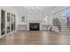 Cozy living room features fireplace, custom built-ins, staircase, and hardwood floors at 2642 Marchmont St, Raleigh, NC 27608