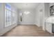 Sunlit living room with hardwood floors, chandelier, and windows offering picturesque views at 2642 Marchmont St, Raleigh, NC 27608