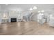 Spacious living room showcasing fireplace, staircase, hardwood floors and kitchen at 2642 Marchmont St, Raleigh, NC 27608
