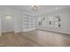 Bright living room featuring a large built-in bookcase, wood floors, and multiple windows at 2642 Marchmont St, Raleigh, NC 27608