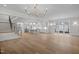 Open-concept living space with hardwood floors, staircase, kitchen, and an abundance of light at 2642 Marchmont St, Raleigh, NC 27608