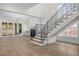 Bright, open living room featuring a staircase, fireplace, chandelier, and hardwood floors at 2642 Marchmont St, Raleigh, NC 27608