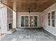 Covered patio with wood ceiling, a fireplace, and large sliding glass doors to merge indoor/outdoor living at 2642 Marchmont St, Raleigh, NC 27608