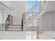 Bright foyer showcasing a staircase with black wrought iron railings and large windows at 2642 Marchmont St, Raleigh, NC 27608