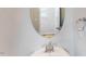 Close up of a powder room sink with chrome faucet, oval mirror, and neutral wall color at 2729 Hunter Woods Dr # 568, Apex, NC 27502