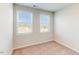 Bedroom with two windows, neutral walls, and neutral carpet at 2729 Hunter Woods Dr # 568, Apex, NC 27502