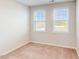 Bedroom features neutral carpet and natural light from two windows with blinds at 2729 Hunter Woods Dr # 568, Apex, NC 27502