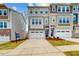 Inviting townhome exterior featuring a two car garage, and manicured landscaping at 2729 Hunter Woods Dr # 568, Apex, NC 27502