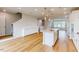 Open concept kitchen with stainless steel appliances, island sink, and hardwood flooring at 2729 Hunter Woods Dr # 568, Apex, NC 27502