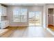 Bright living room with hardwood floors, and large windows with sliding glass door to the outside deck at 2729 Hunter Woods Dr # 568, Apex, NC 27502