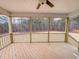 Screened-in back porch with wood flooring, ceiling fan, and a scenic view of the backyard and woods at 320 Duncan Creek Rd # 161, Lillington, NC 27546