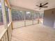 Spacious screened-in back porch features wood flooring, ceiling fan, and views of the outdoors at 320 Duncan Creek Rd # 161, Lillington, NC 27546