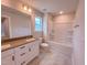 Well lit bathroom with a large vanity, toilet, and bathtub with shower at 320 Duncan Creek Rd # 161, Lillington, NC 27546