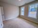 Well-lit bedroom with two windows and neutral walls, enhancing spacious feel at 320 Duncan Creek Rd # 161, Lillington, NC 27546