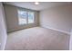 A bedroom with carpet, a window, and white trim at 320 Duncan Creek Rd # 161, Lillington, NC 27546