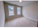 Bright bedroom with two windows letting in natural light and neutral carpet at 320 Duncan Creek Rd # 161, Lillington, NC 27546