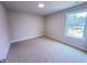 A bedroom with carpet, a window, and white trim at 320 Duncan Creek Rd # 161, Lillington, NC 27546