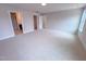 Large carpeted primary bedroom with natural light from a large window at 320 Duncan Creek Rd # 161, Lillington, NC 27546