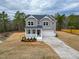 Charming two-story home with a welcoming front porch and attached two-car garage at 320 Duncan Creek Rd # 161, Lillington, NC 27546