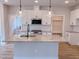 Modern kitchen featuring a granite island, stainless steel appliances, and white cabinets at 320 Duncan Creek Rd # 161, Lillington, NC 27546