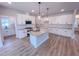 Modern kitchen with island, stainless steel appliances, and neutral color palette at 320 Duncan Creek Rd # 161, Lillington, NC 27546