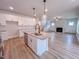 Modern kitchen island view of a living room with a fireplace and stainless steel appliances at 320 Duncan Creek Rd # 161, Lillington, NC 27546
