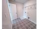 Bright laundry room with patterned flooring, connections and wire shelf at 320 Duncan Creek Rd # 161, Lillington, NC 27546