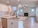 View from the kitchen island into a living room with a fireplace and modern staircase at 320 Duncan Creek Rd # 161, Lillington, NC 27546