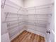 Organized walk-in pantry with wire shelving for ample storage space and wood-style flooring at 320 Duncan Creek Rd # 161, Lillington, NC 27546