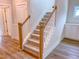 Carpeted staircase with stained handrail and white risers creates an inviting transition to the next level at 320 Duncan Creek Rd # 161, Lillington, NC 27546
