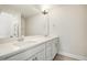 Bright bathroom features a double vanity with white cabinets and a quartz countertop at 472 Traditions Grande Blvd # 34, Wake Forest, NC 27587