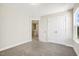 Bedroom with neutral walls and carpet, featuring a closet and a view of the staircase at 472 Traditions Grande Blvd # 34, Wake Forest, NC 27587