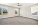 A spacious bedroom featuring carpet, neutral-toned walls, a ceiling fan, and natural lighting at 472 Traditions Grande Blvd # 34, Wake Forest, NC 27587