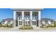A community clubhouse boasts elegant architectural details and a welcoming entrance, complemented by colorful flowers at 472 Traditions Grande Blvd # 34, Wake Forest, NC 27587