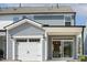 Two-story home with blue and gray siding, white garage door, and covered porch at 472 Traditions Grande Blvd # 34, Wake Forest, NC 27587