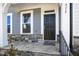 Charming front door with stone accent and covered porch, offering a warm welcome at 472 Traditions Grande Blvd # 34, Wake Forest, NC 27587