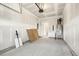 Spacious garage with a concrete floor, water heater, and interior door at 472 Traditions Grande Blvd # 34, Wake Forest, NC 27587
