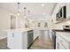 Bright kitchen with white cabinets, stainless steel appliances, and an island with a sink at 472 Traditions Grande Blvd # 34, Wake Forest, NC 27587
