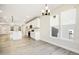 Bright modern kitchen with white cabinets, stainless steel appliances, and ample counter space with windows at 472 Traditions Grande Blvd # 34, Wake Forest, NC 27587