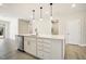 Kitchen with white cabinets and stainless steel appliances, and island with dishwasher and sink at 472 Traditions Grande Blvd # 34, Wake Forest, NC 27587