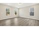 Bright and airy living room featuring hardwood floors and multiple windows at 472 Traditions Grande Blvd # 34, Wake Forest, NC 27587