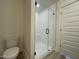 Modern bathroom features a glass-enclosed shower with a seat and a sleek white toilet at 476 Traditions Grande Blvd # 33, Wake Forest, NC 27587