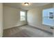 A neutral bedroom with two windows providing lots of natural light at 476 Traditions Grande Blvd # 33, Wake Forest, NC 27587