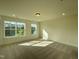 Sun-filled bedroom features plush carpeting, neutral walls, and large windows at 476 Traditions Grande Blvd # 33, Wake Forest, NC 27587