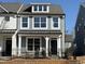 Charming two-story home with gray siding, black door, and black iron fence at 476 Traditions Grande Blvd # 33, Wake Forest, NC 27587