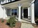 Charming home featuring stone accents, gray siding, white pillars, and a covered front porch at 476 Traditions Grande Blvd # 33, Wake Forest, NC 27587